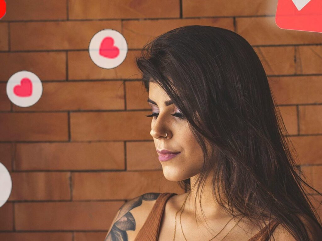 Woman using smartphone in cafe with social media notifications around.